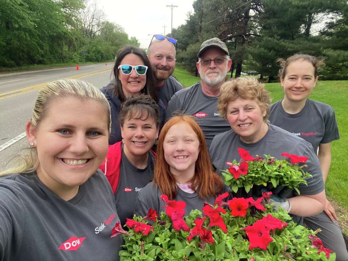 Midland residents help plant flowers along Eastman Avenue on May 21, 2022.