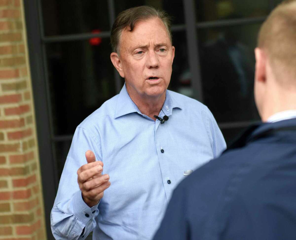 Gov. Ned Lamont tours an apartment building in May 2022 in Norwalk, Conn., which has among the highest average rents in Connecticut.