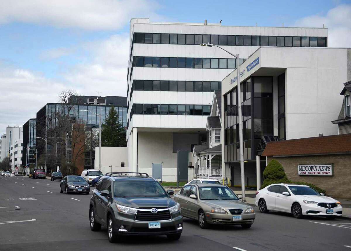 Traffic moves south past a row of mostly commerical office buildings on Summer Street in Stamford, Conn. Sunday, March 27, 2022. The Stamford Neighborhood Coalition filed a petition last week calling for the repeal of a sweeping set of zoning changes passed by the board at a March meeting.