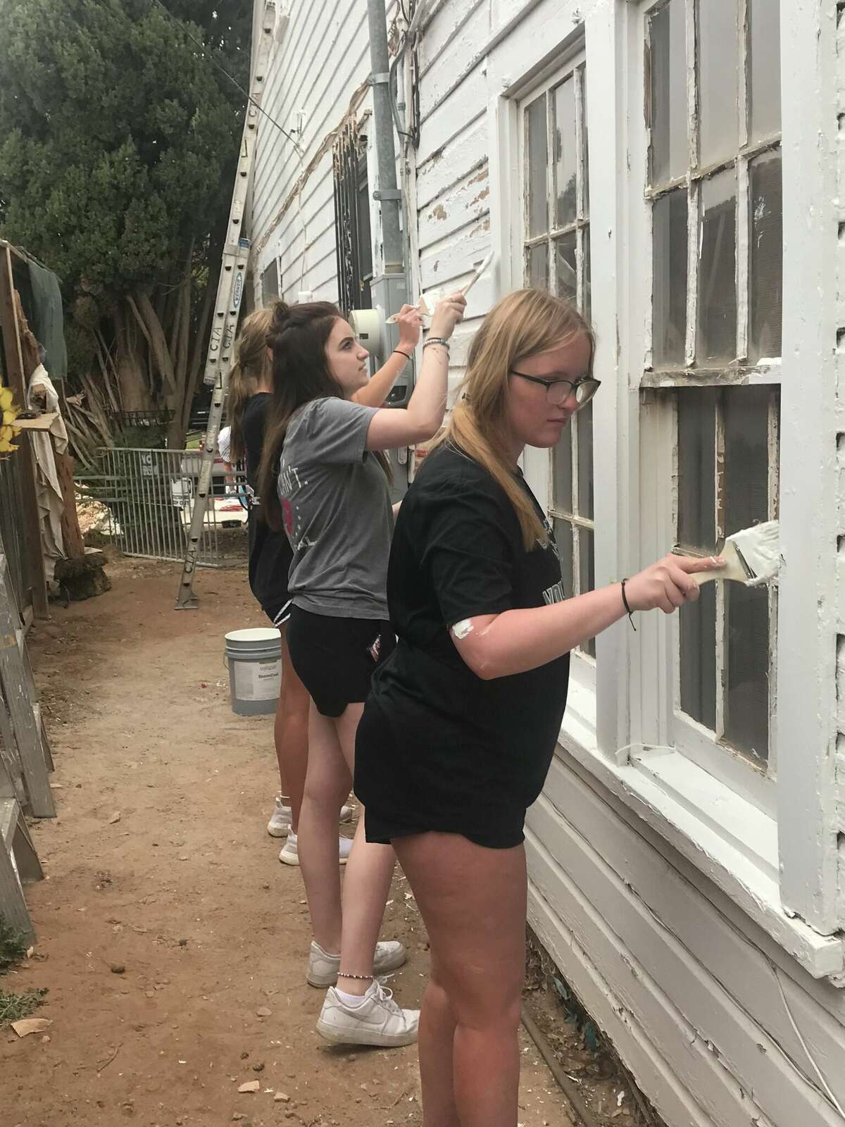 Midland Christian seniors from Keisha Grizzard’s Bible class scraped and painted a Christmas in Action recipient’s home in Midland. 