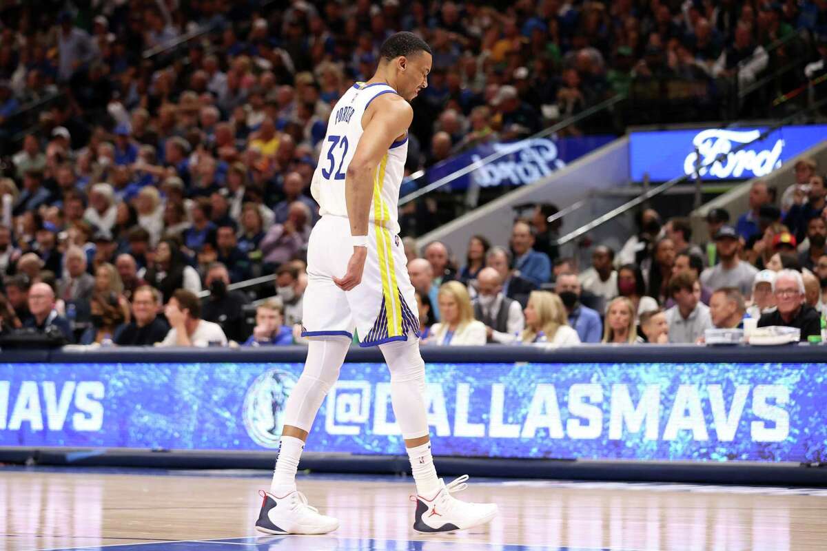 Golden State Warriors’ Otto Porter, Jr. limps off the court after re-injuring his foot in 2nd quarter against Dallas Mavericks during Game 3 of NBA Western Conference Finals at American Airlines Center in Dallas, Texas, on Sunday, May 22, 2022.