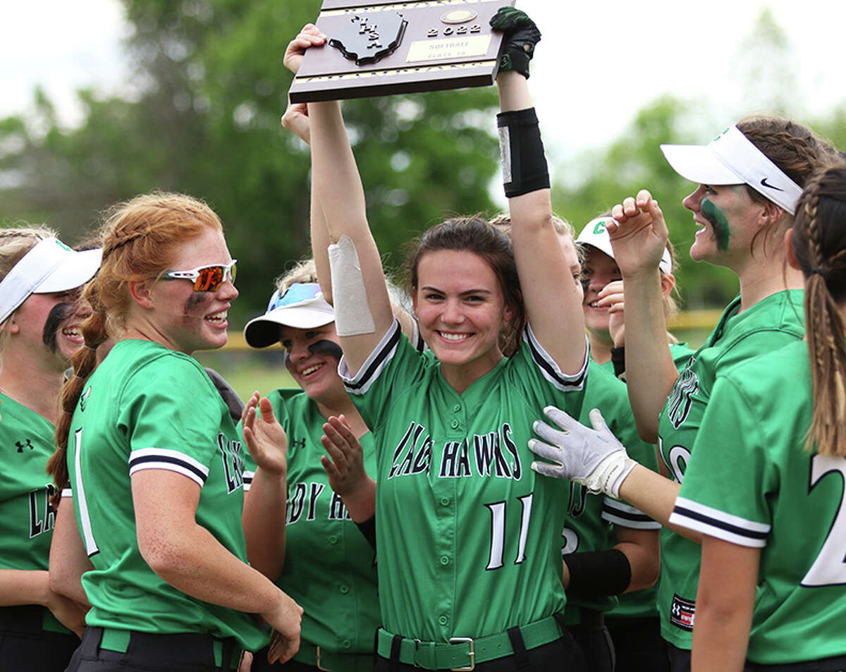 Carrollton senior Marissa Cox (11) holds up the regional plaque after the Hawks defeated Nokomis in the a Class 1A regional championship game Monday in Bunker Hill.  
