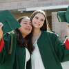 The Woodlands High School seniors Isabel Bonilla and Vivian Roberts pose for a photo before a graduation ceremony at Cynthia Woods Mitchell Pavilion, Monday, May 23, 2022, in The Woodlands.