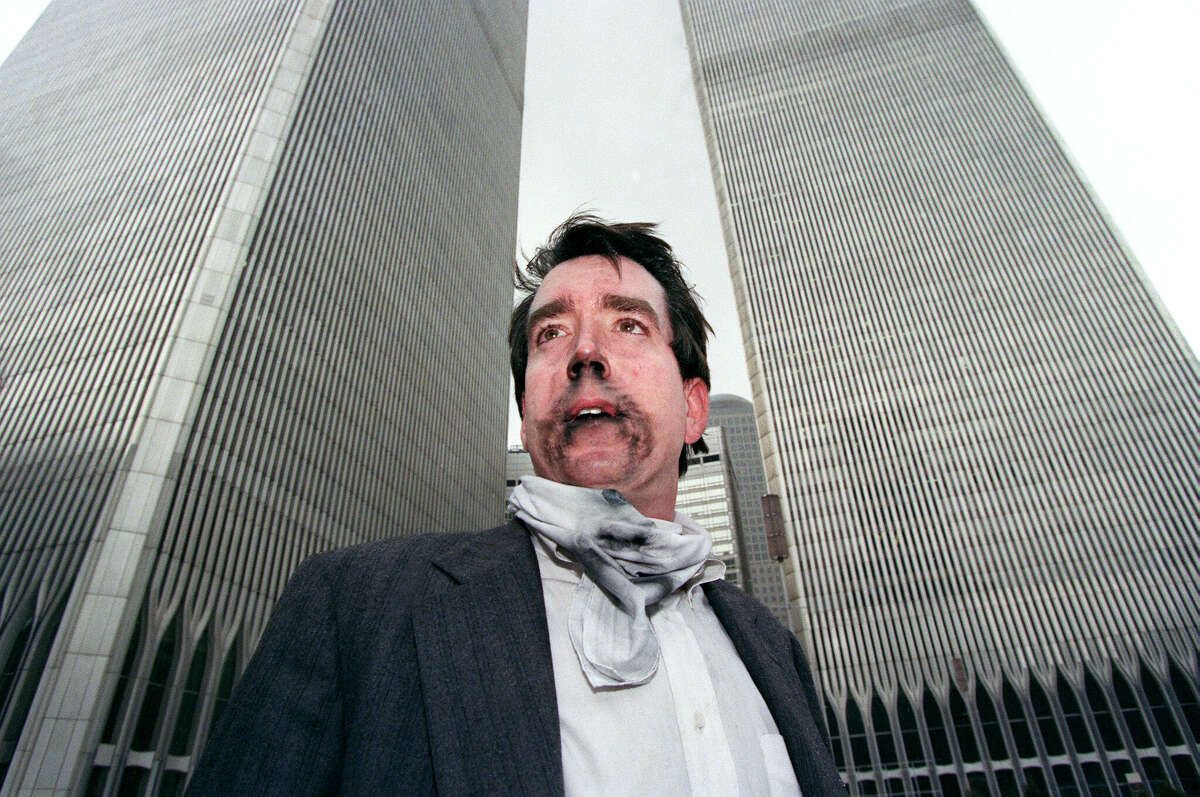 Brian Rolford stands outside the World Trade Center after walking down from the 105th floor, 26 February 1993, after a car bomb exploded in a parking garage, killing six people and injuring scores more. The attack was planned by a group of islamists terrorists including Ramzi Yousef and Sheik Omar Abdel-Rahman who was sentenced to life imprisonment in October 1995 for masterminding the bombing. (Photo credit should read TIMOTHY A. CLARY/AFP/GettyImages)