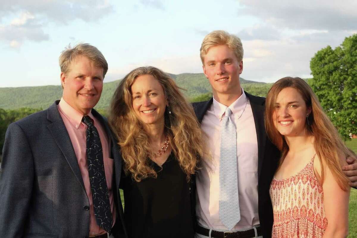 Competitive cyclist Anna Moriah “Mo” Wilson, seen with her parents Eric and Karen Wilson and brother Matt in a family photo, was fatally shot in a friend’s home in Austin.