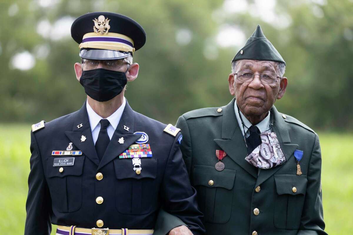 Warrant Officer Gregory Illich, left, escorts Pfc. Romie Hollins during the 4th Annual Memorial Day Celebration at the Sweet Rest Cemetery, Monday, May 31, 2021, in Tamina. Tamina’s Memorial Day ceremony and fundraiser on Monday will focus on raising funds to build a new home for Hollins.