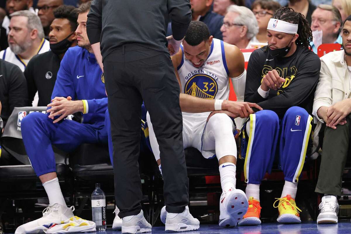 Warriors forward Otto Porter, Jr. reacts to reinjuring his foot in the second quarter of Game 3 against the Mavericks.