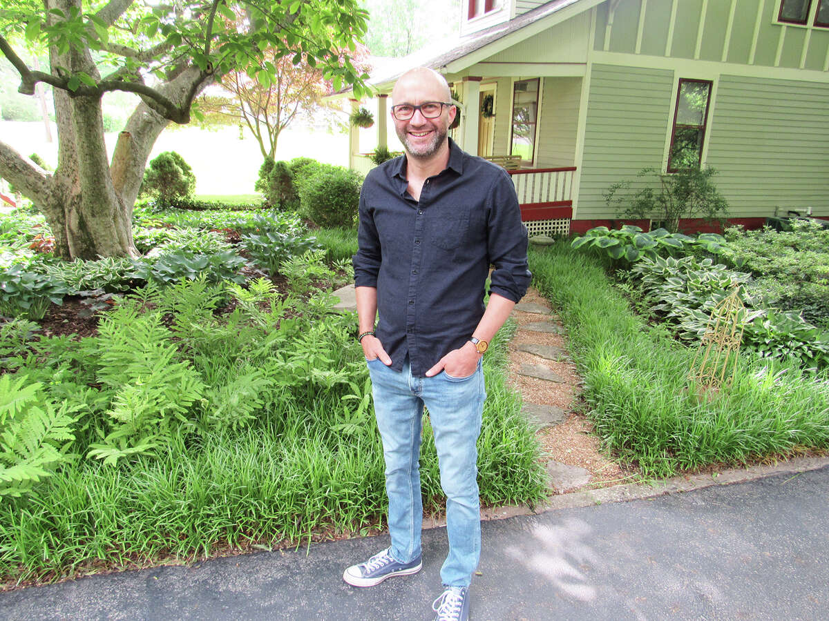 Chris Smejkal poses in front of his home garden in Edwardsville, which will be among eight featured for the 22nd annual Edwardsville-Glen Carbon Area Garden Tour on June 10-11.