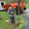 An installer for Greenlight Networks cable company puts fiber optic cable in the ground.