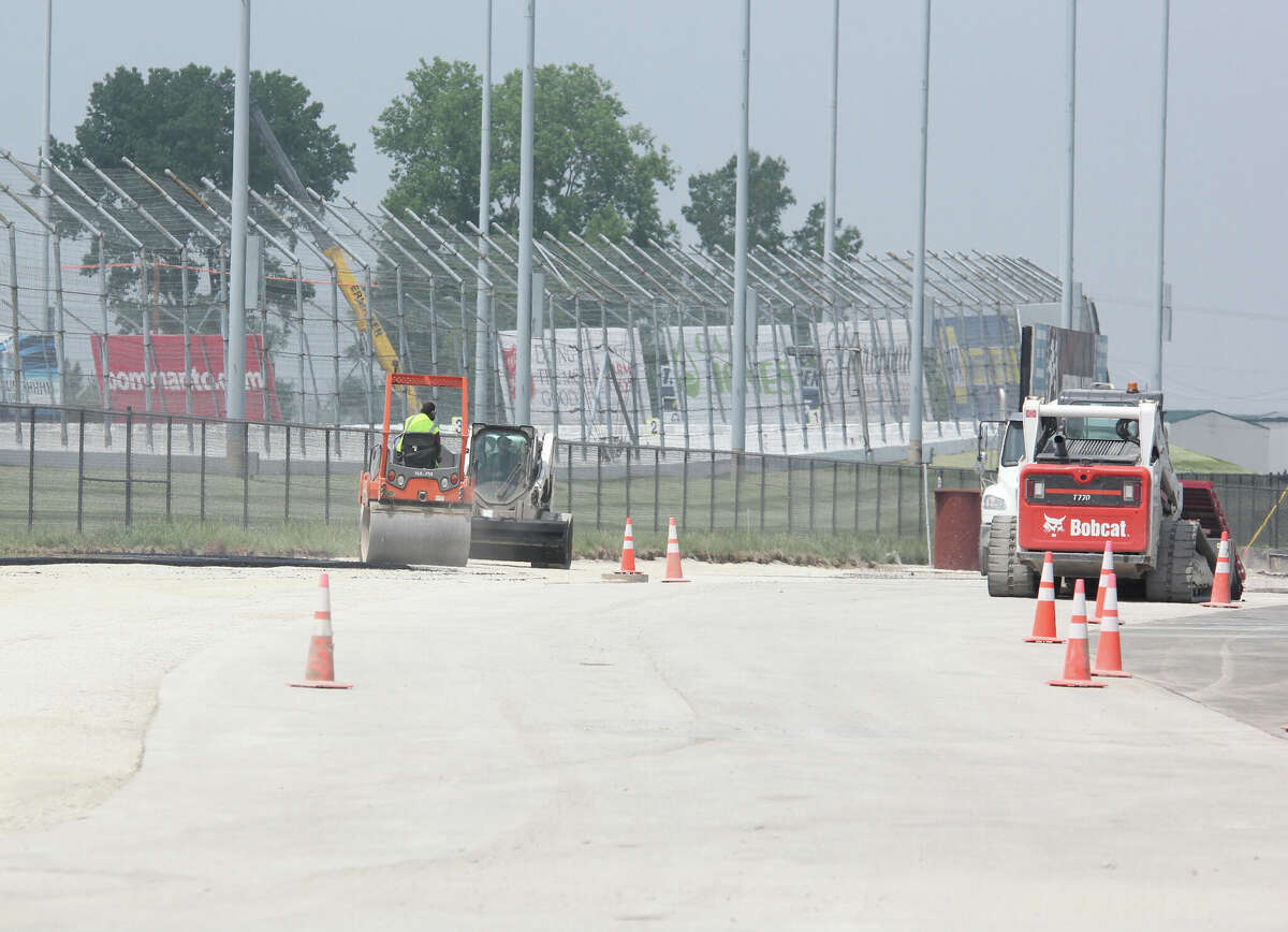 Workers prepare public roadways in front of Turn 3 at World Wide Technology Raceway in Madison for the large crowds expected for the June 5 Enjoy Illinois 300, the first NASCAR Cup Series race in the track's history.