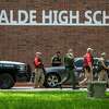 Law enforcement officials work Tuesday, May 24, 2022 at Uvalde High School after a shooting was reported earlier in the day at nearby Robb Elementary School.