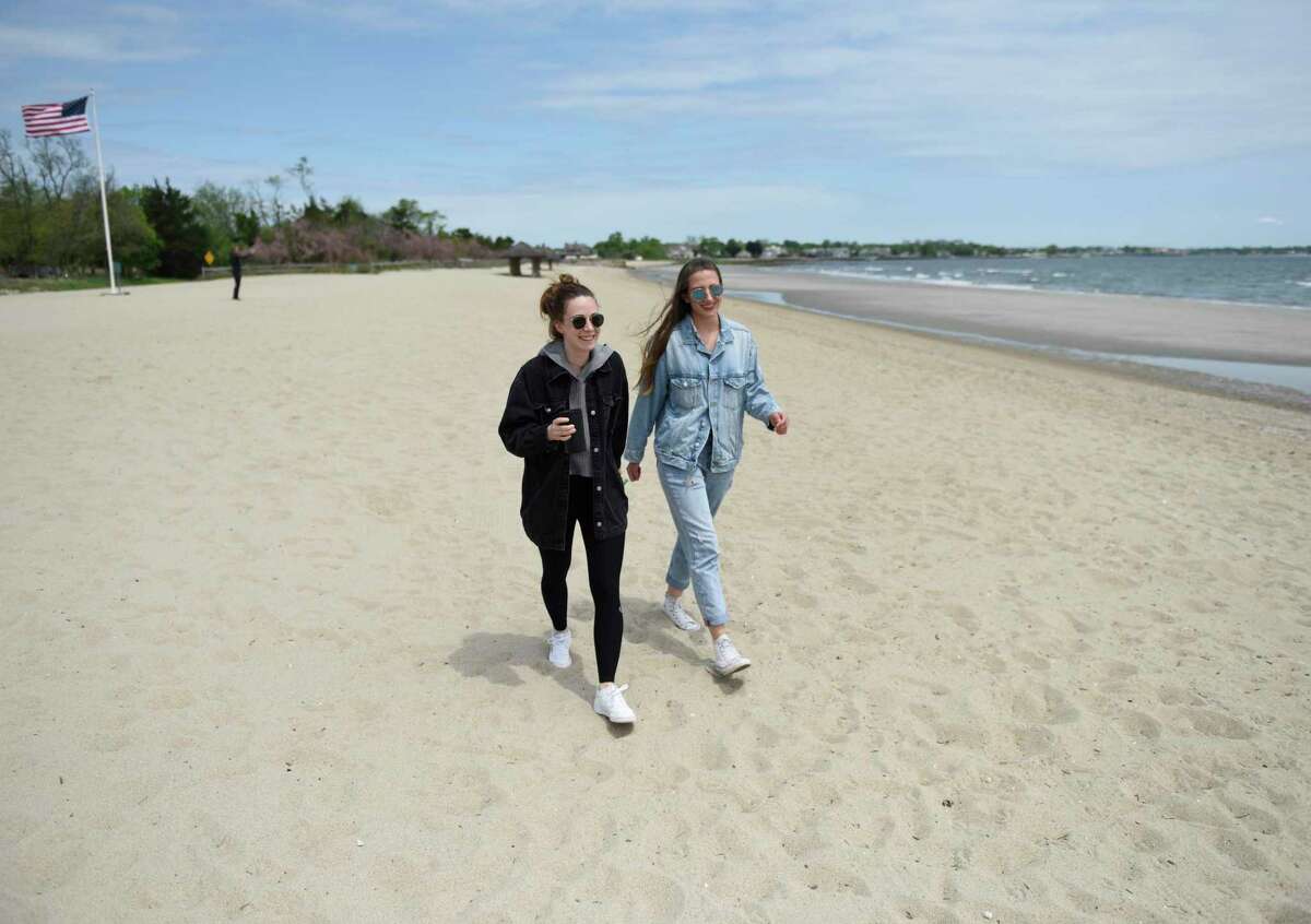 Selina Schmitt, left, and Josephin Merten, of Greenwich, walk on the beach at Greenwich Point Park in Old Greenwich on Tuesday, May 24.
