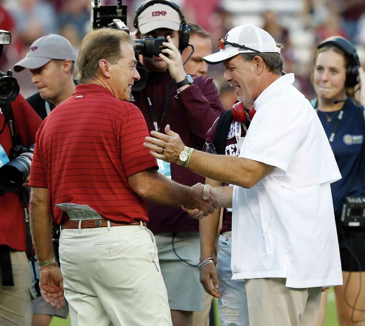 Coach Nick Saban of the Alabama Crimson Tide and coach Jimbo Fisher of the Texas A&M Aggies meet before the game at Kyle Field on Oct. 9, 2021 in College Station.