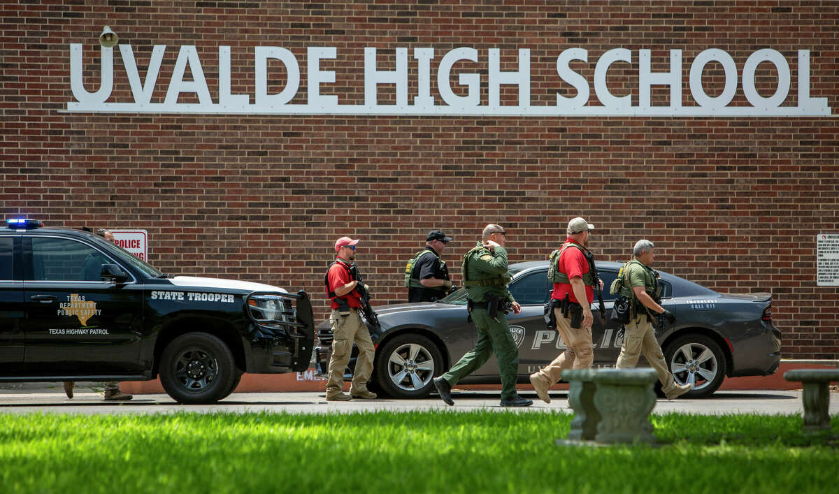 Law enforcement personnel walk outside Uvalde High School after a shooting at Robb Elementary School, Tuesday, May 24, 2022, in Uvalde, Texas. (William Luther/The San Antonio Express-News via AP)