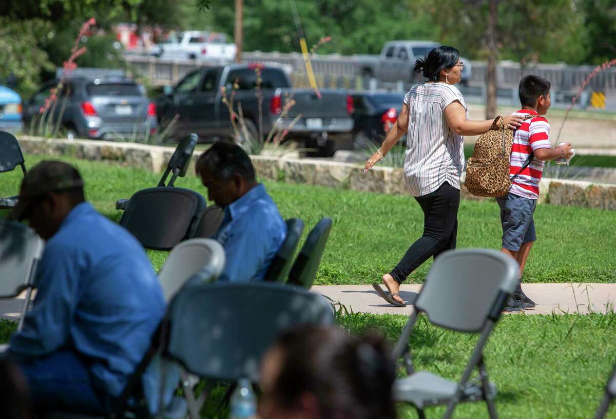 A woman and a child leave the Uvalde Civic Center Tuesday May 24, 2022. At least 14 students and 1 teacher were killed will a gunman opened fire at Robb Elementary School in Uvalde according to Texas Gov. Greg Abbott.