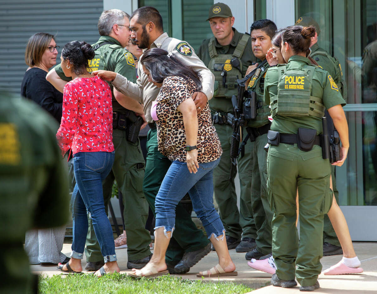 People leave the Uvalde Civic Center following a shooting earlier in the day at Robb Elementary School, Tuesday, May 24, 2022, in Uvalde, Texas. (William Luther/The San Antonio Express-News via AP)