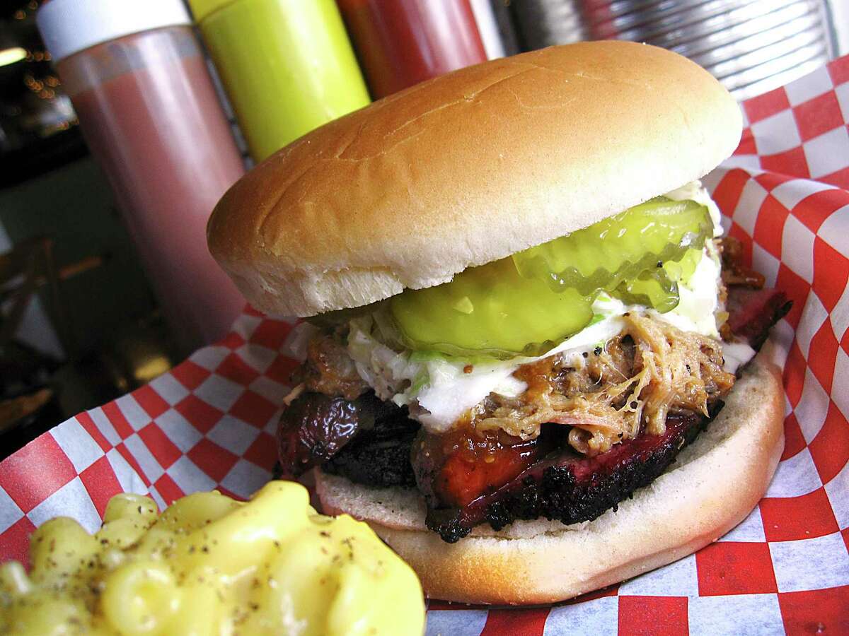 The Big Tex BBQ Sammich with brisket, pulled pork, sausage, coleslaw and pickles is one of the favorites at Alamo BBQ Co. on East Grayson Street, which will close after its last service on Memorial Day.