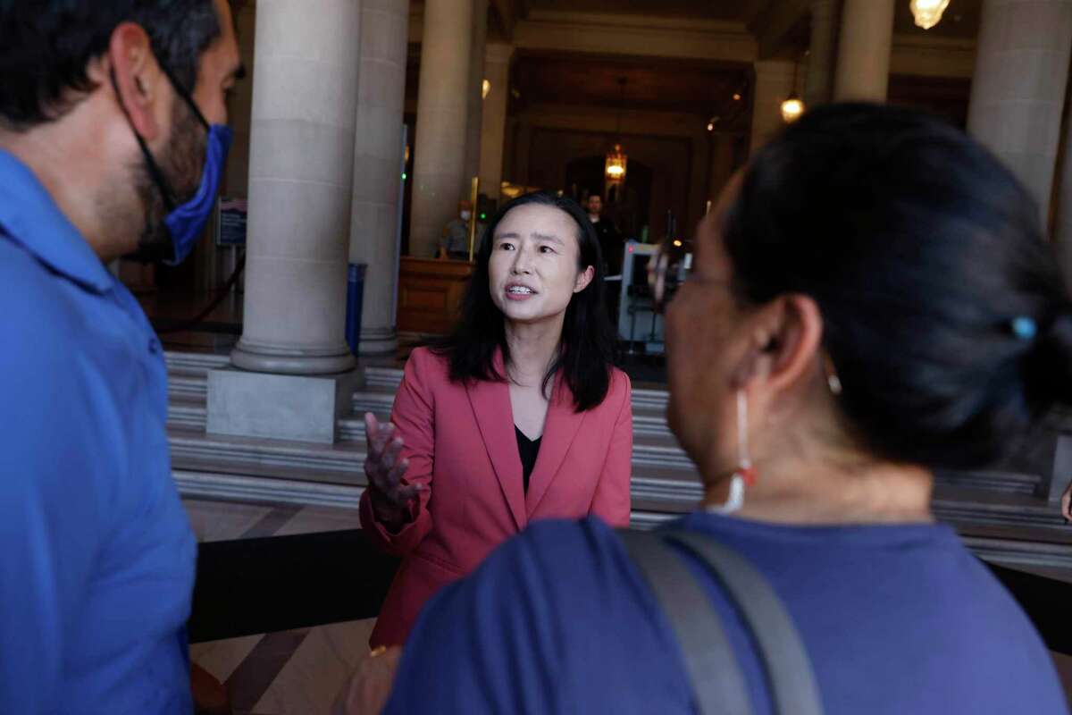 Supervisor Connie Chan (center) talks with Frank Lara, executive vice president of the United Educators of San Francisco, and Anabel Ibañez, political director of the UESF, after a press conference at City Hall regarding an affordable housing charter amendment Supervisor Chan was introducing for the November ballot.