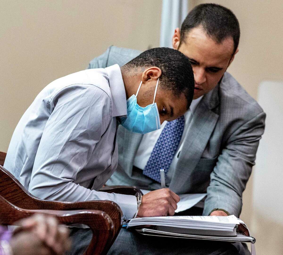 Known as the ‘Medical Center rapist’ for his previous conviction, Anton Harris, left, signs paperwork Tuesday with his attorney, Jonathan Watkins. Harris pleaded guilty to aggravated sexual assault and his sentencing Wednesday will resolve four remaining sex assault charges against him.