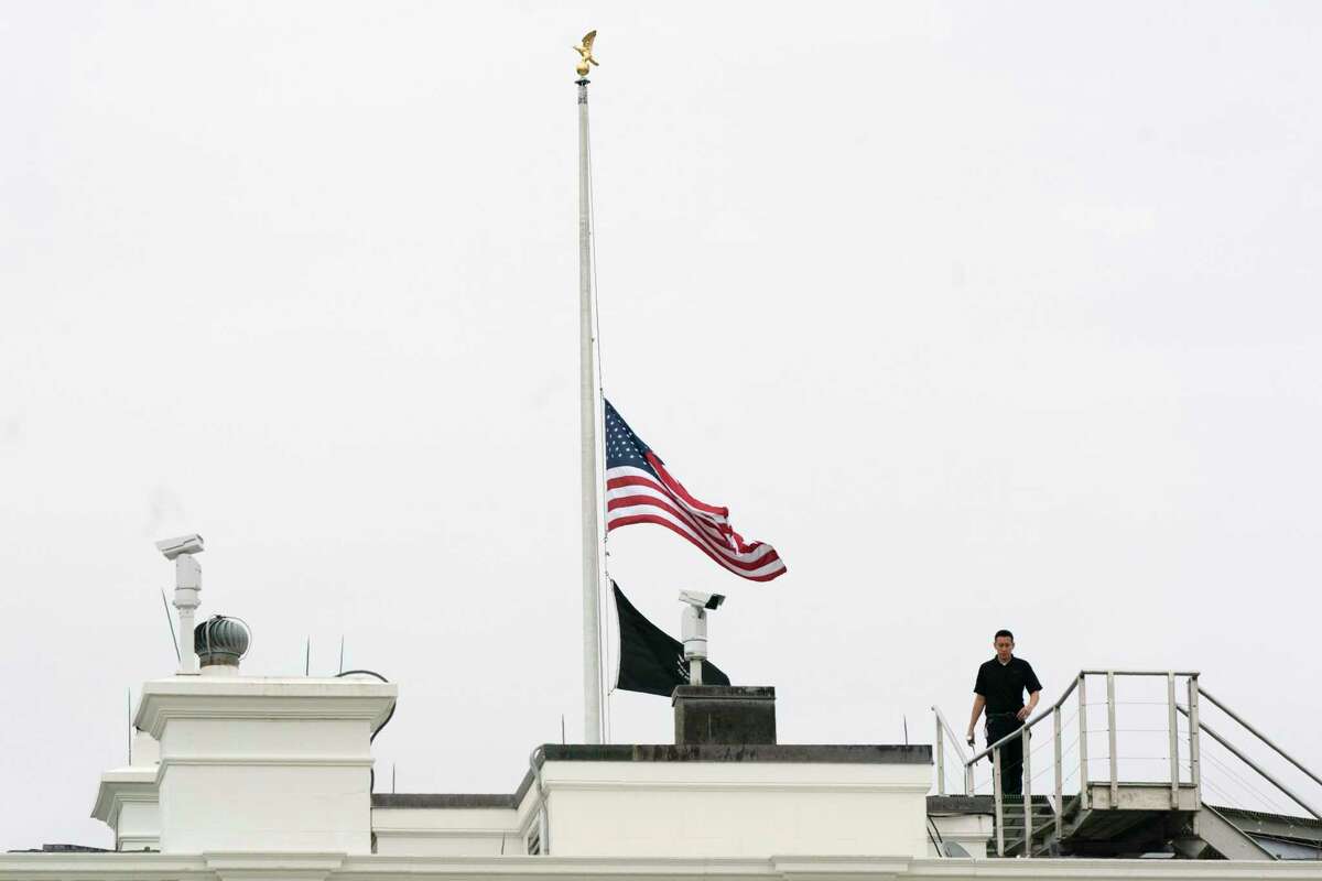An American flag flies at half-staff at the White House on Tuesday to honor the victims of the mass shooting at Robb Elementary School in Uvalde, Texas.