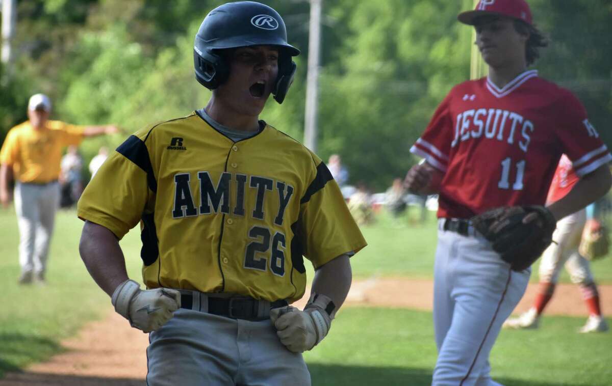 Amity's Nick Clark celebrates after scoring during the SCC baseball semifinals gam,e between Amity and Fairfield Prep, at Amity High, Woodbridge on Tuesday, May 24, 2022.