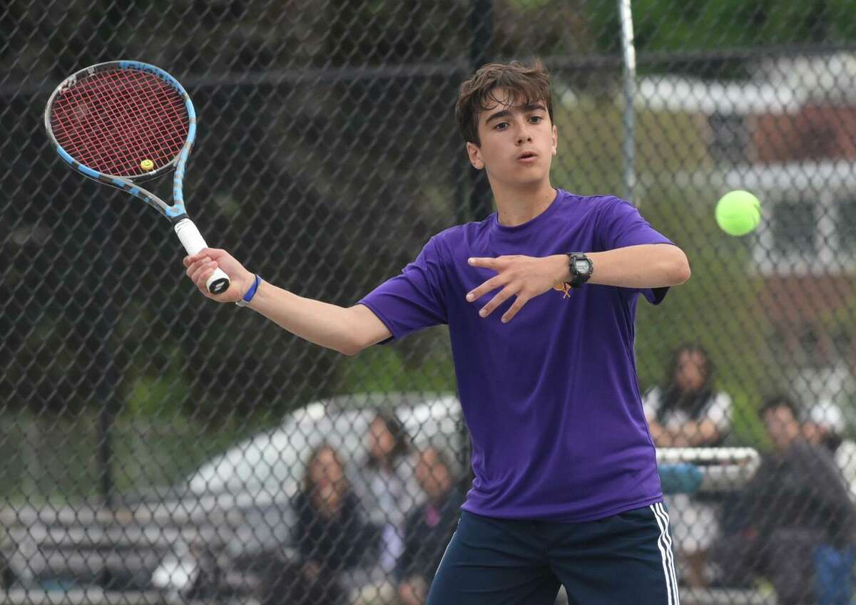 Westhill No. 2 singles player Ryan Karan hits a return during the FCIAC boys tennis championship against Staples on Tuesday in Wilton.