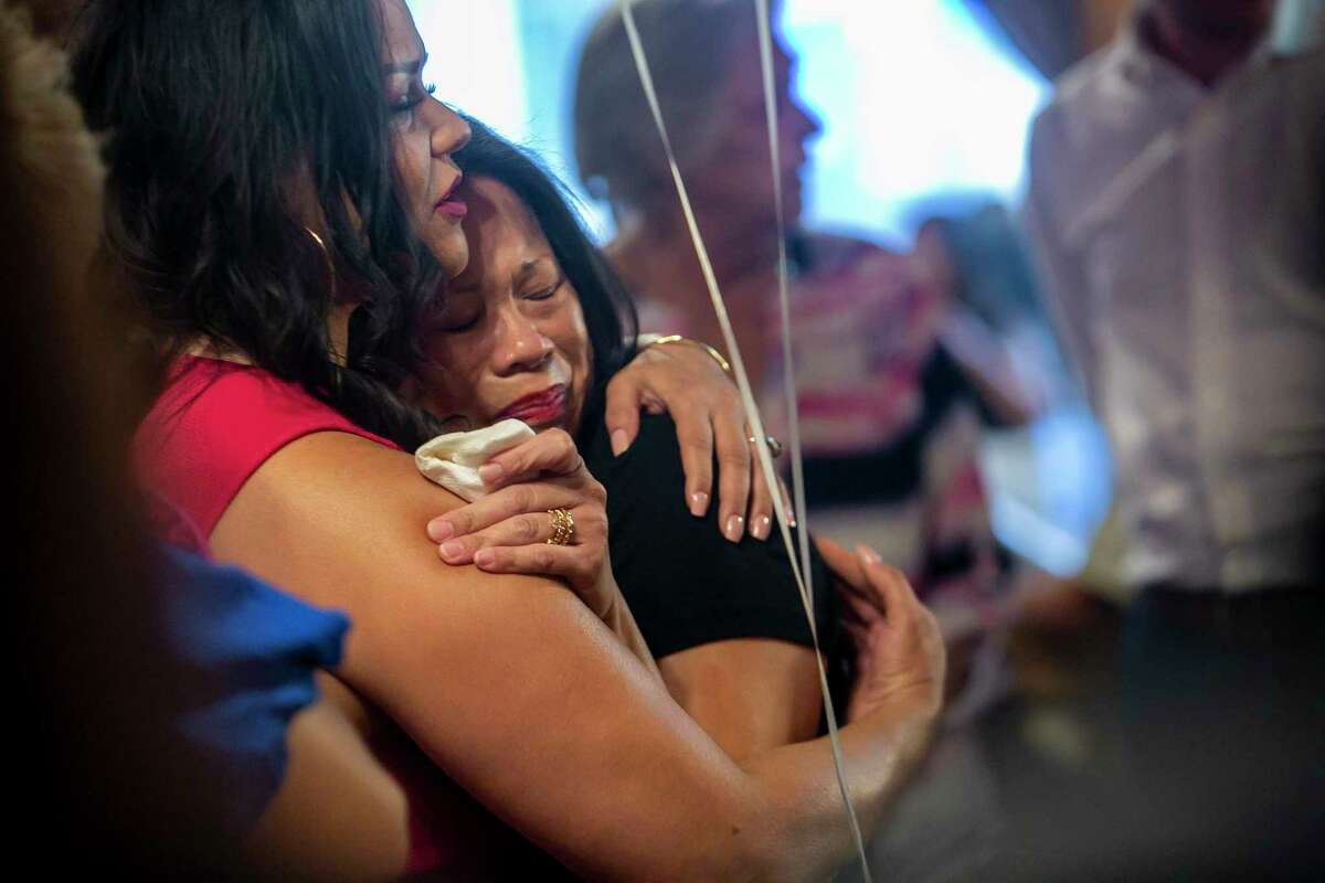 Supporters of Bexar County Judge Democratic candidate and State Rep. Ina Minjarez tearfully embrace during her campaign watch party at Acadiana Cafe in San Antonio, Texas, on May 24, 2022.