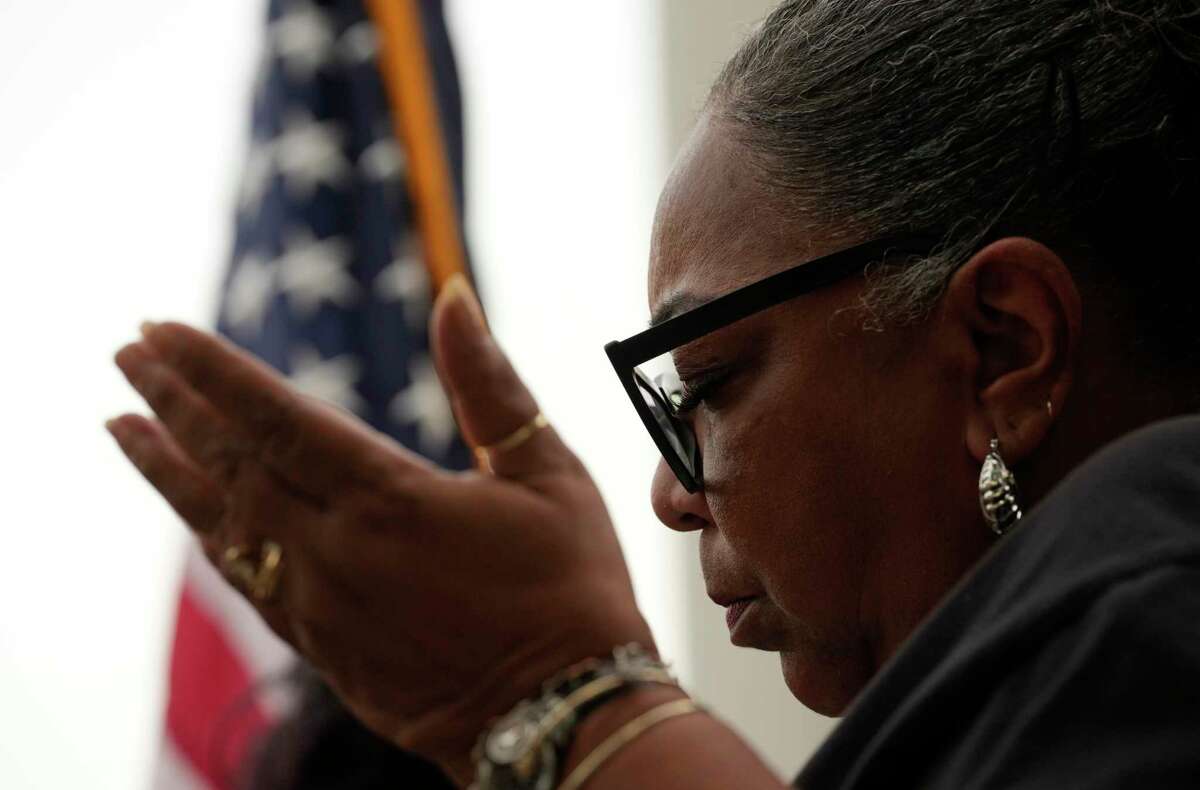 Kathy Blueford-Daniels, an HISD trustee, prays during a press conference and vigil for victims of the mass shooting at an elementary school in Uvalde, Texas, on Tuesday, May 24, 2022, at the George Thomas “Mickey” Leland Federal Building in Houston. Blueford-Daniels lost her son to gun violence almost 16 years ago. “I’m a broken mother,” she said.
