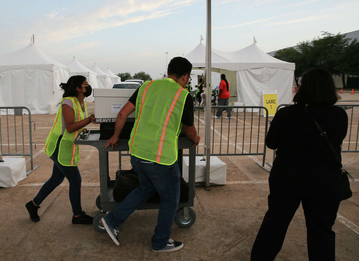 Volunteers transporting the first returned voting equipment from the drop-off site to the Central Count Tuesday, May 24, 2022, at NRG Arena in Houston.