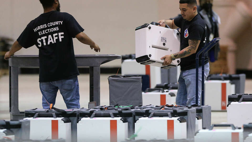 Harris County staff unloads voting equipment that have gone through certification at Central Count Tuesday, May 24, 2022, at NRG Arena in Houston.