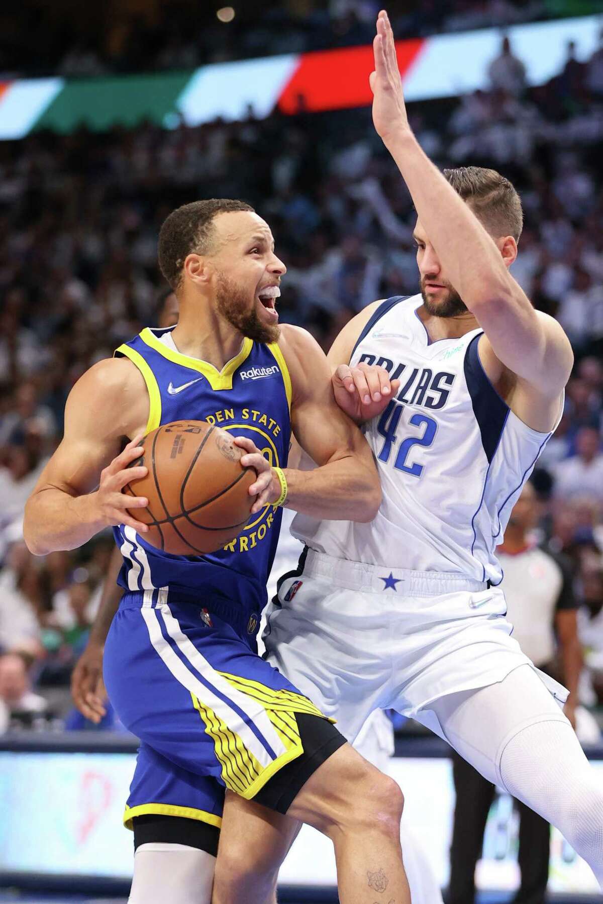 Golden State Warriors’ Stephen Curry drives against Dallas Mavericks’ Maxi Kleber in 1st quarter of Game 4 of NBA Western Conference Finals at American Airlines Center in Dallas, Texas, on Tuesday, May 24, 2022.