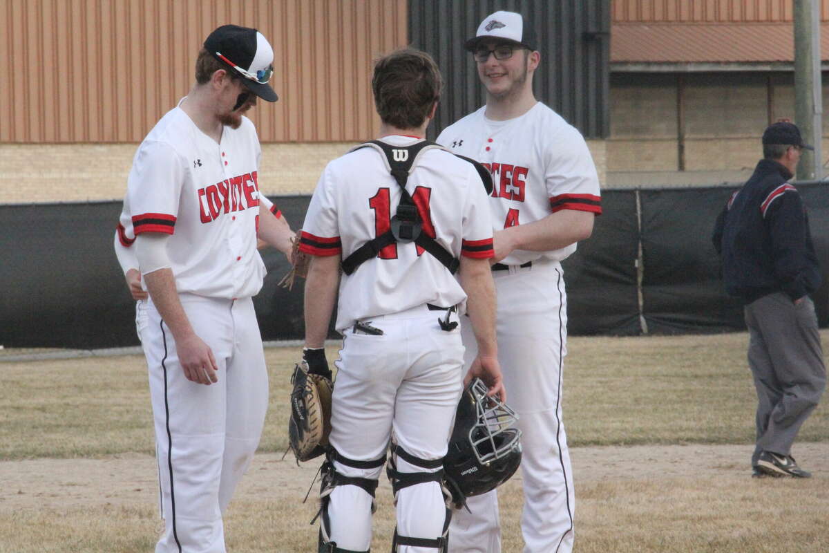 Noah Morgan (right) and Isaac Williams 14) discuss strategy with a teammate during the regular season. Reed City clinched the CSAA Gold title on Tuesday.