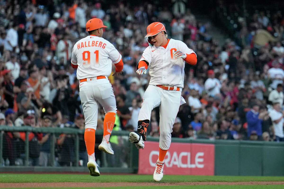 San Francisco Giants' Joc Pederson, right, celebrates with third base coach Mark Hallberg (91) after hitting a two-run home run against the New York Mets during the third inning of a baseball game in San Francisco, Tuesday, May 24, 2022. (AP Photo/Tony Avelar)