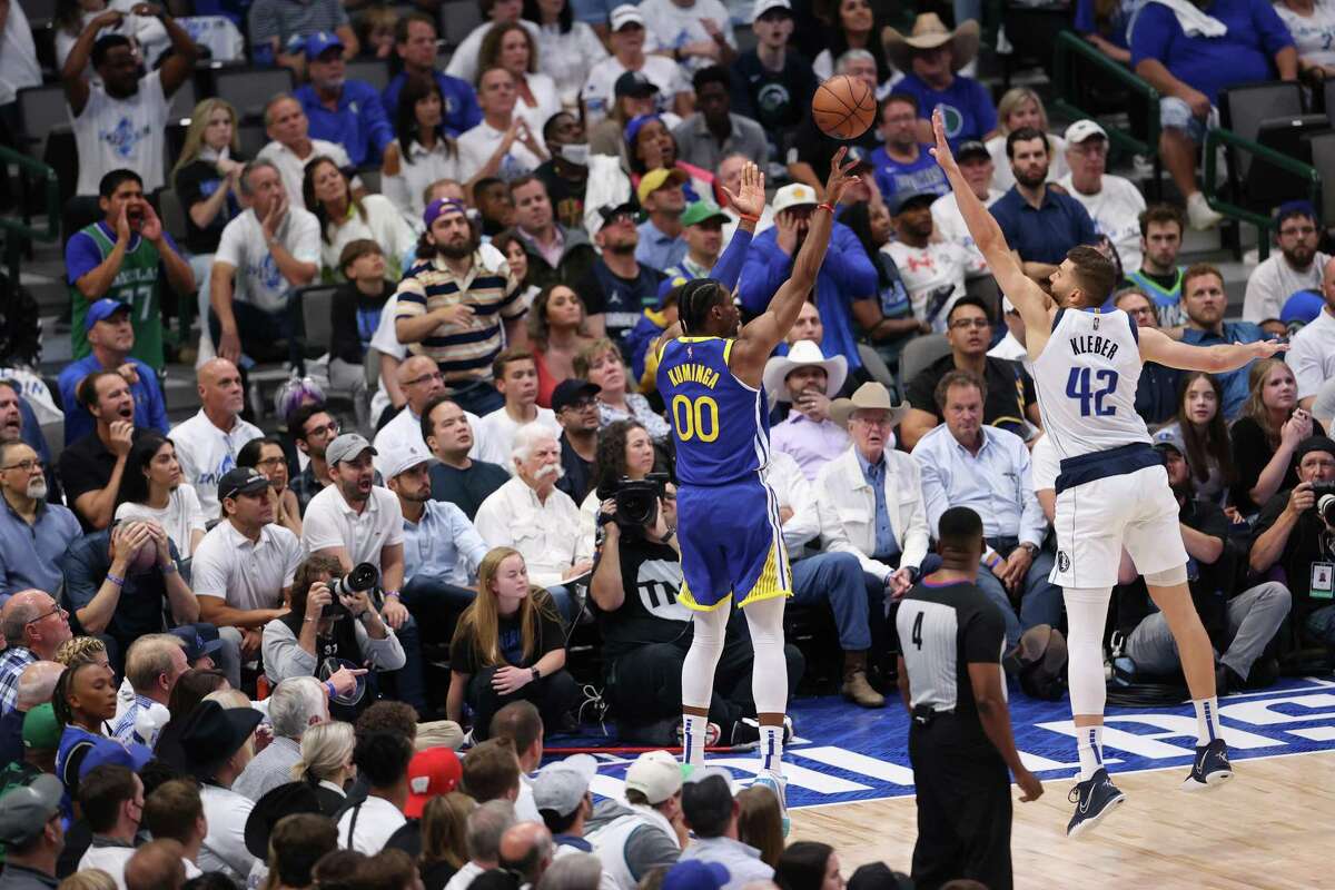 Golden State Warriors’ Jonathan Kuminga hits a 3-pointer against Dallas Mavericks’ Maxi Kleber in 4th quarter of Mavs’ 119-109 win in Game 4 of NBA Western Conference Finals at American Airlines Center in Dallas, Texas, on Tuesday, May 24, 2022.