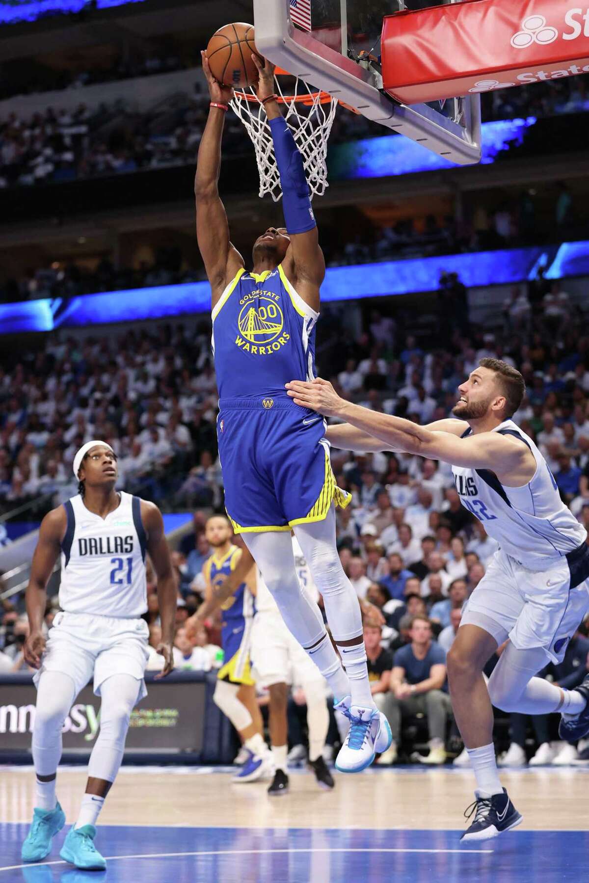 Golden State Warriors’ Jonathan Kuminga is fouled by Dallas Mavericks’ Maxi Kleber in 1st quarter of Game 4 of NBA Western Conference Finals at American Airlines Center in Dallas, Texas, on Tuesday, May 24, 2022.