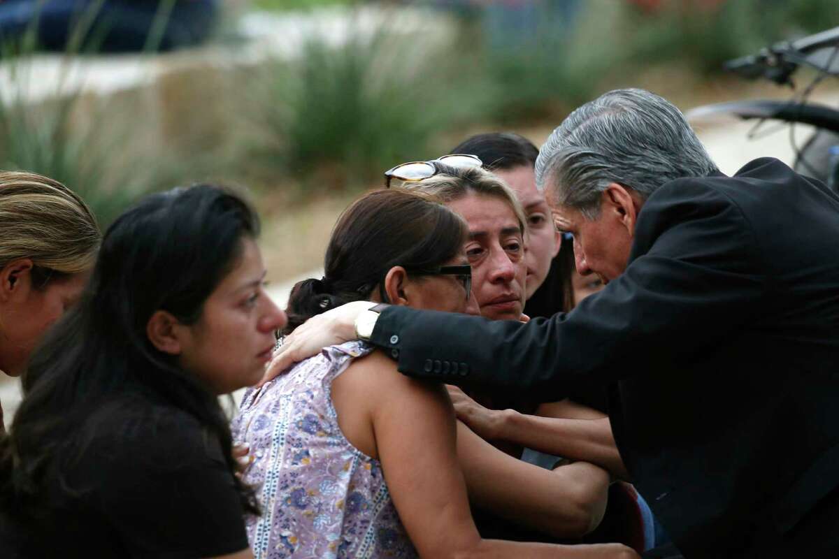 CORRECTS SPELLING TO GARCIA-SILLER, INSTEAD OF GARCIA SELLER - The archbishop of San Antonio, Gustavo Garcia-Siller, comforts families outside the Civic Center following a deadly school shooting at Robb Elementary School in Uvalde, Texas, Tuesday, May 24, 2022.