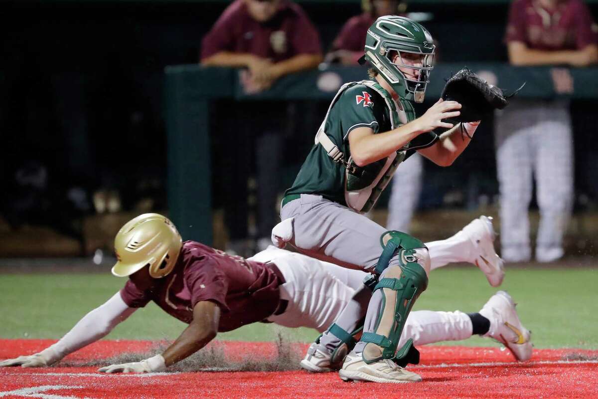 Strake Jesuit catcher Matt Evans, front, waits for the throw as Summer Creek runner William Hill, behind, slides to score during their Region III-6A quarterfinal baseball game held at the Univeristy of Houston Friday, May 20, 2022 in Houston, TX.