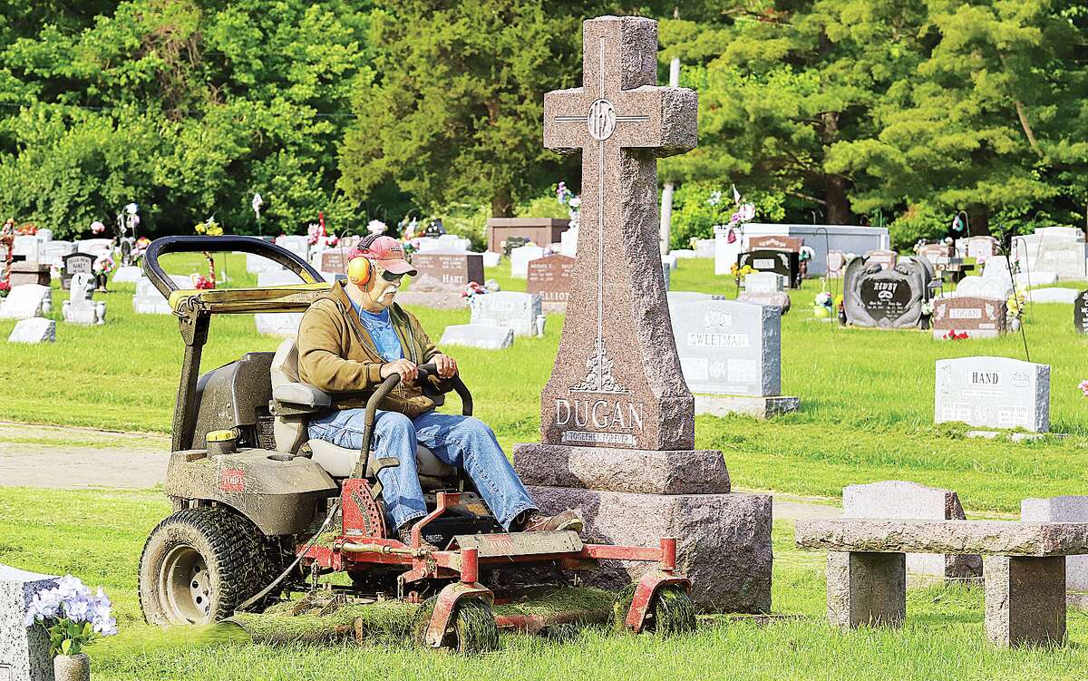 John Badman|The Telegraph The crew at the Upper Alton Cemetery was busy Tuesday mowing and trimming as they prepared for Memorial Day visitors this weekend. Several events are scheduled in the Riverbend for the holiday weekend, some for the first time since the pandemic closures.