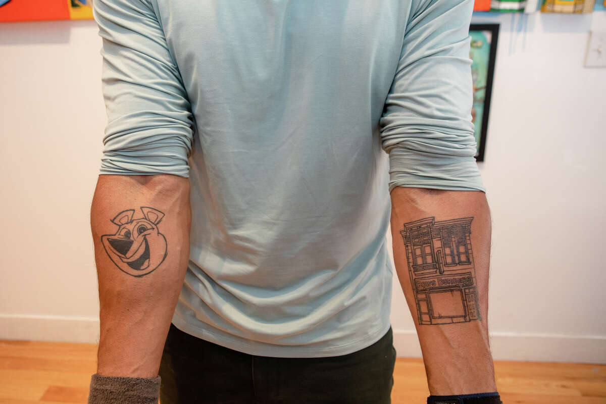Illustrator Sirron Norris shows tattoo's of his artwork, which includes Bob's Burgers, at his art studio in San Francisco, Calif. on May 3, 2022.