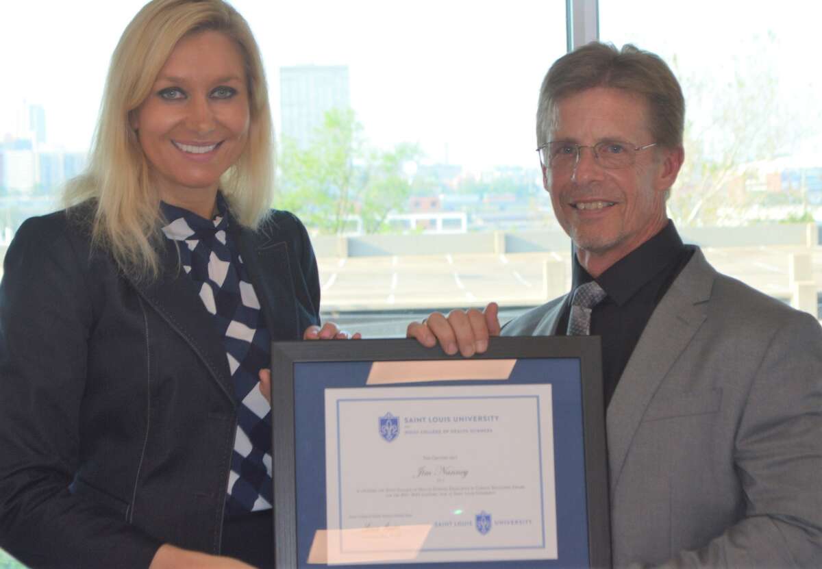 Cathy Sabolo, Health Center Manager at SIHF Healthcare in Bunker Hill, left, presents James Nanney, PA-C, with the 2022 Excellence in Clinical Education Award from Doisy College of Health Sciences at Saint Louis University.
