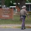 TOPSHOT - An officer walks outside of Robb Elementary School in Uvalde, Texas, on May 24, 2022. - An 18-year-old gunman killed 14 children and a teacher at an elementary school in Texas on Tuesday, according to the state's governor, in the nation's deadliest school shooting in years. (Photo by allison dinner / AFP) (Photo by ALLISON DINNER/AFP via Getty Images)