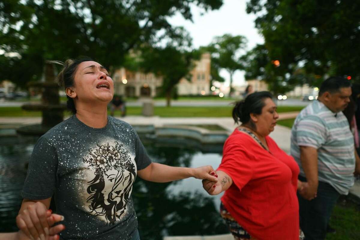 Kladys Castellón prays during a vigil for the victims of a mass shooting at Robb Elementary School in Uvalde, Texas, on Tuesday, May 24, 2022.
