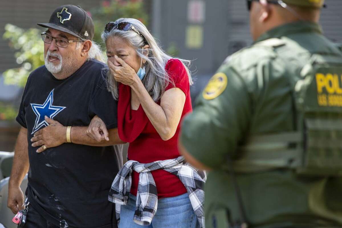 A woman cries as she leaves the Uvalde Civic Center, Tuesday May 24, 2022, in Uvalde, Texas An 18-year-old gunman opened fire Tuesday at a Texas elementary school, killing multiple children and a teacher and wounding others, Gov. Greg Abbott said, and the gunman was dead.