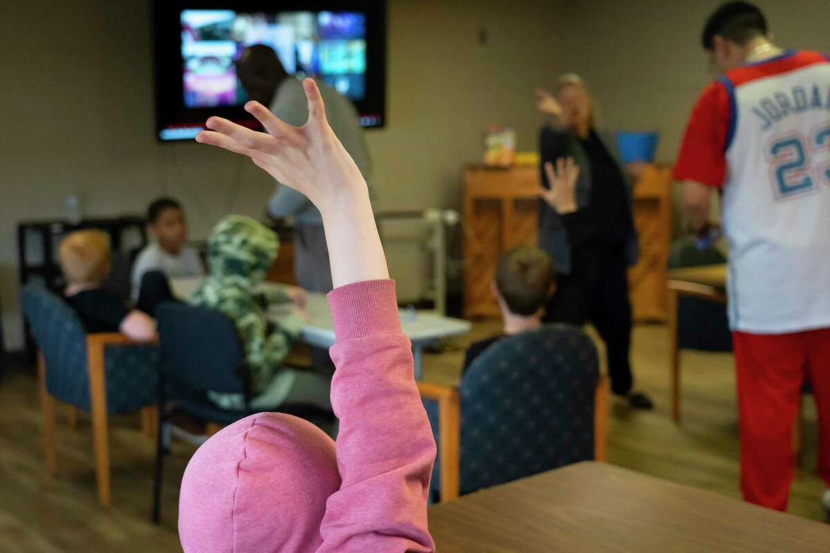 Sanger ISD’s director of student intervention, Ann Hughes, calls on a student raising their hand to answer a question in a social skills class at the Linda Tutt Learning Center, Tuesday, March 8, 2022, in Sanger. Sanger Independent School District has taken a holistic approach, beefing up its own resources and partnering with the community, creating one of the best-resourced districts in Texas.