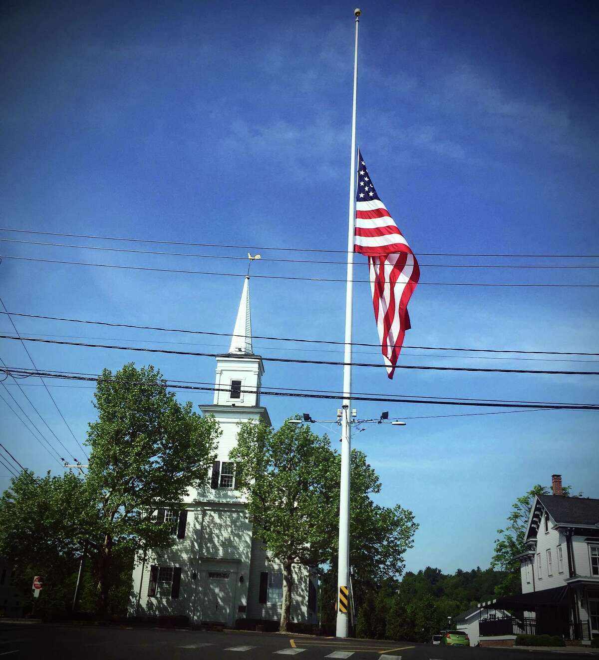 The U.S. flag on Main Street in Newtown, Conn., was lowered in honor of the victims of the shooting at a school in Uvalde, Texas, on May 24, 2022.
