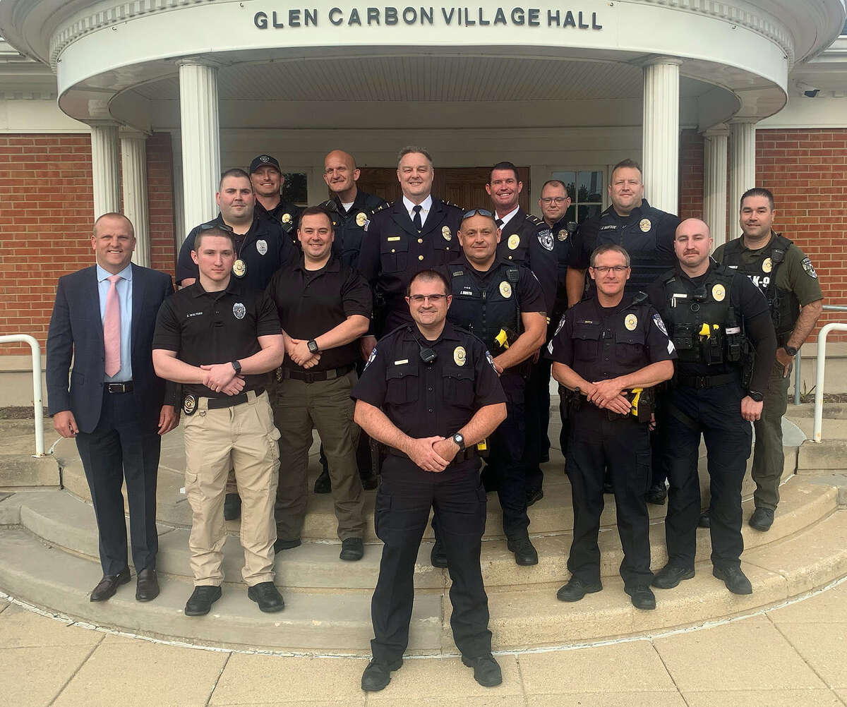 New Glen Carbon Police Officer Shaun Benyr, front and center, poses with fellow officers who attended his swearing in Tuesday.