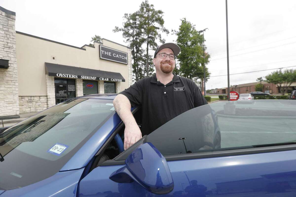 Justin Vough is seen with his recently purchased Camaro, Tuesday, May 24, 2022, in Conroe. Vough, who served 14 years in prison, is now an assistant manger with The Catch restaurant and saved part of his salary for the car after taking part in Eagles Nest Ministries’ Soaring Eagles Academy to give inmates a soft landing as they re-enter society.