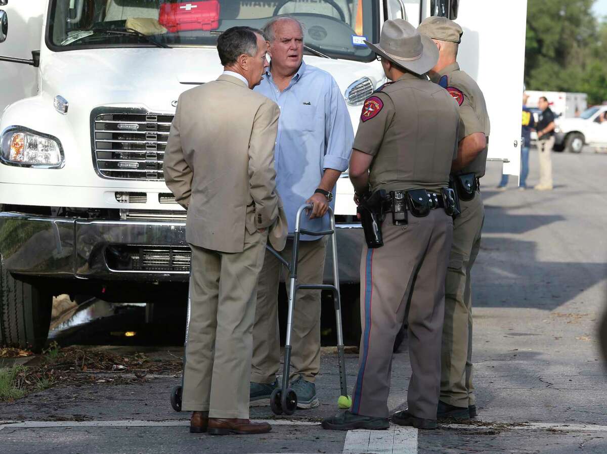 Uvalde Mayor Don McLaughlin, using a walker, speaks with Texas Department of Public Safety troopers outside Robb Elementary School. He told CNN that the "truth will come out."
