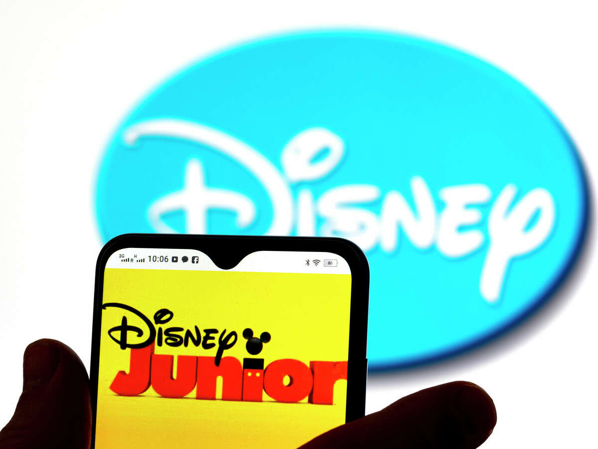 UKRAINE - 2022/01/23: In this photo illustration, the Disney Junior logo is seen displayed on a smartphone screen with a Disney logo in the background. (Photo Illustration by Igor Golovniov/SOPA Images/LightRocket via Getty Images)
