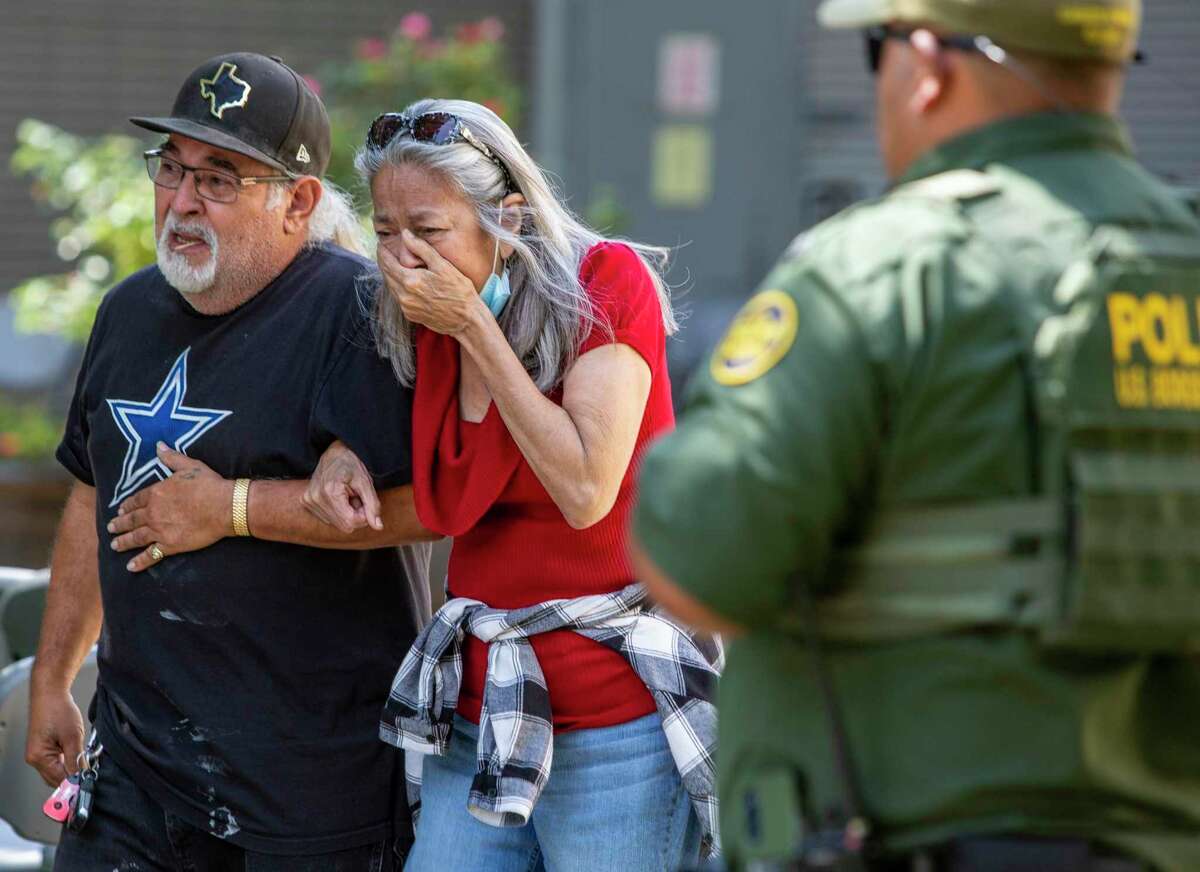 A woman leaves the Uvalde Civic Center after the mass shooting killed at least 19 children Tuesday, less than two weeks after 10 were shot to death in Buffalo, N.Y.